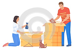 Man and woman packing things in cardboard boxes. Couple moving house