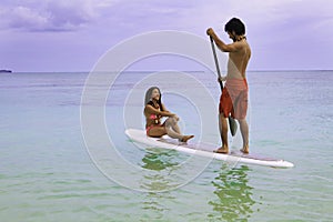 Man and woman on paddle board