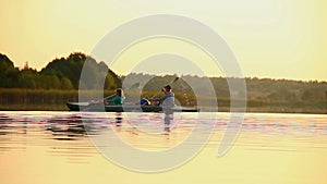 Man and woman paddling boat synchronously. Team-building, sport