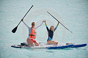 Man and woman paddling on sup board