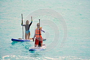 Man and woman paddling on sup board