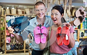Man and woman with pairs of jandals in store photo
