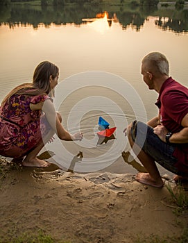 Man and woman paper boats