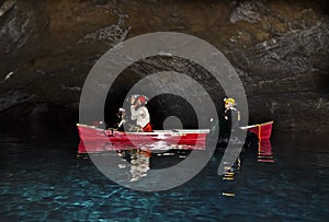 Man and Woman Photographing inside Lava Tube Lake Cave