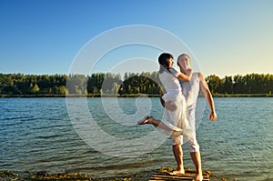 Man and woman on a pier on sunset