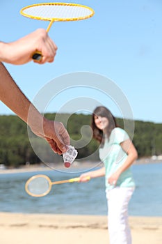 Man and woman playing badminton