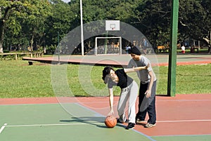 Man and Woman Playing Basketball - Horizontal