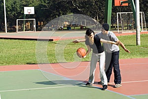 Man and Woman Playing Basketball - Horizontal