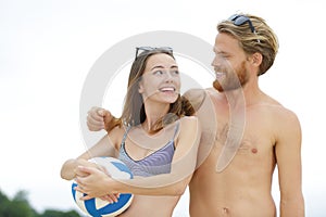 man and woman playing beach volley together