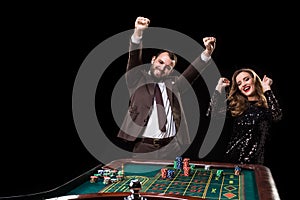 Man with woman playing roulette at the casino. Addiction to the