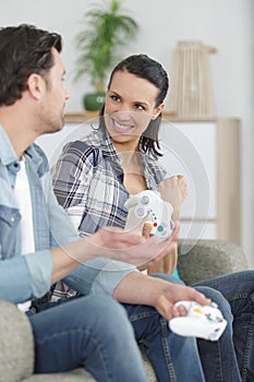man and woman playing video game at home