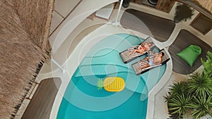 Man And Woman At Pool. Top View Of Couple In Love Enjoying Summer Vacation In Villa.