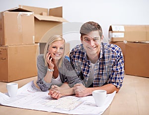 Man, woman and portrait with floor plan of new home for renovation or moving boxes, apartment or relocation. Couple