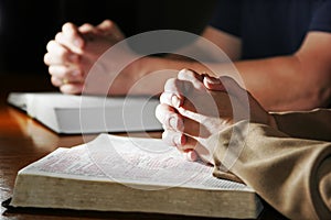 Man & Woman Praying Bibles