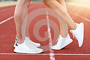 Man and woman racing on outdoor track