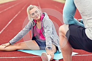 Man and woman racing on outdoor track