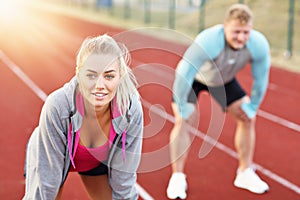 Man and woman racing on outdoor track