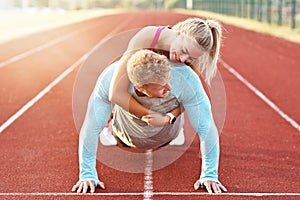 Man and woman racing on outdoor track