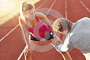 Man and woman racing on outdoor track