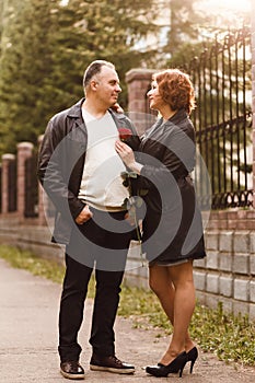 Man and woman with a red rose in summer in the outdoors