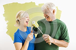 Man and woman relaxing while painting.