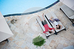 Man and woman relaxing on sunbeds