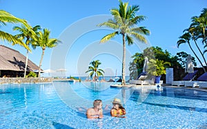 Man and Woman relaxing in a swimming pool, a couple on a honeymoon vacation in Mauritius