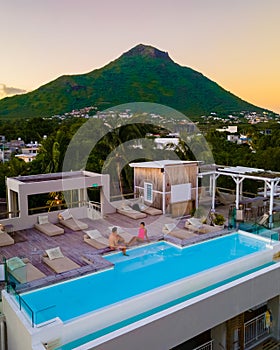 Man and Woman relaxing in a swimming pool, a couple on a honeymoon vacation in Mauritius