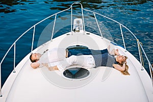 Man and a woman relaxing on a yacht.