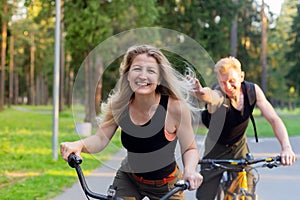 Man and woman ride bikes through the woods