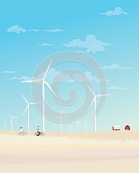 Man and woman riding bicycle together in countryside fields with wind turbines and blue sky background