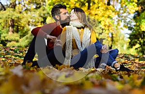 Man and woman with romantic faces on autumn trees background