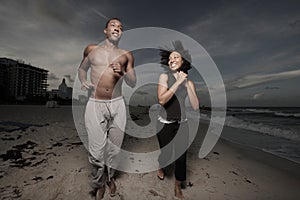 Man and woman running on the beach