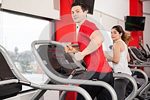 Man and woman running at the gym