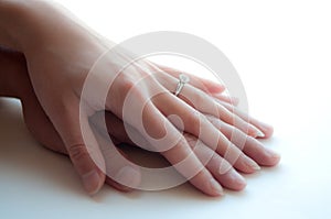 Man and Woman's hands with Diamond Ring