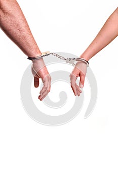 Man and woman's hands handcuffed together concept of love