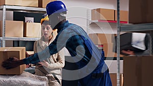 Man and woman scanning goods in warehouse depot