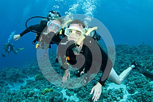 Man and woman scuba dive togeather