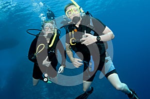Man and woman scuba dive togeather