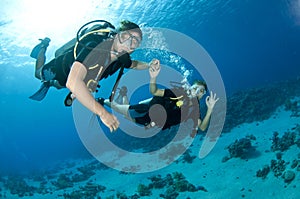 Man and woman scuba dive togeather