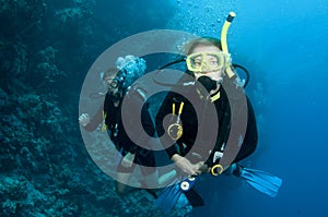 Man and woman scuba dive togeather