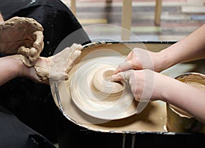 Man and woman sculpt with clay. Clay modeling training on a potters wheel. Art, creativity. Modeling clay, cultural traditions,