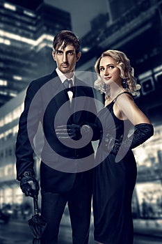 Man and woman secret agents and spies. Film noir. Retro style fashion portraits against the backdrop of the night city