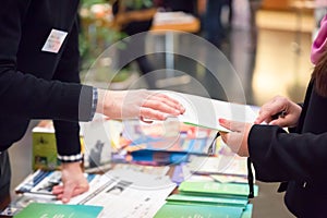 Man and Woman Sharing Information Leaflet over Exhibition Stand