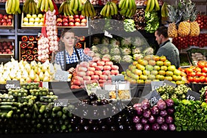 Two sellers laying out vegetables photo