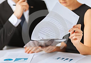 Man and woman signing contract paper