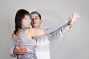 Man and woman in silver dress dancing waltz photo