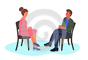 Man and woman sit in chairs opposite each other