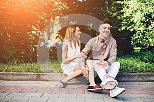 Man and woman sitting on the curb