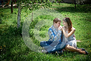 Man and woman sitting on the grass